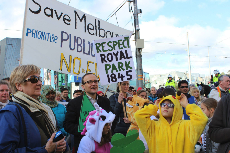 Adam Bandt plus little friends in animal onesies.