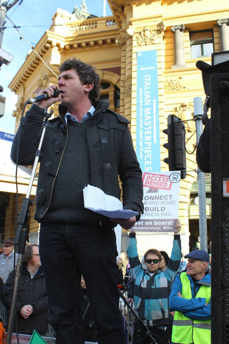 Anthony Main addresses #Rally4PT at Flinders Street. Note the Extend the rail line to Mernda supporter!