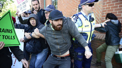 Clash ... Police grab east-west link protesters outside the Collingwood offices. Photo: Penny Stephens 